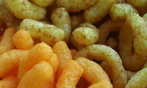Chrupki kukurydziane na diecie, pomarańczowe i żółte, kuszą lekką teksturą.