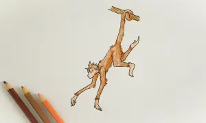 Dibujo de un mono naranja colgado de una rama, con lápices de colores al lado.