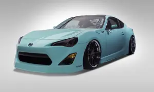 Turkusowy Scion FR-S z przyciemnionymi światłami i czarnymi felgami, gotowy do jazdy.