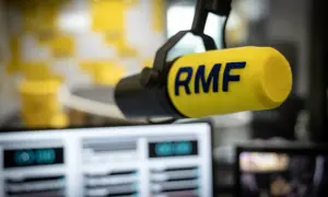 Mikrofon studyjny RMF z żółtym futerkiem i niebieskim logo.