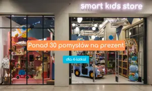 Witryna sklepu z zabawkami "smart kids store" z pomarańczowym napisem "Ponad 30 pomysłów na prezent" i niebieskim "dla 4-latka!".