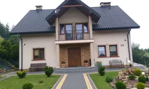 Piękny dom w Brzeźnicy z zadbanym ogrodem, kamienną ścieżką i ozdobnym kamiennym skalniakiem.