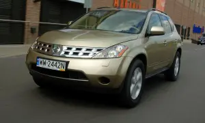 Złoty Nissan Murano 3.5 V6 w ruchu miejskim, z widocznym numerem rejestracyjnym WW 2442N.