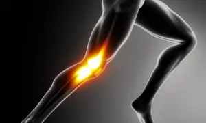 Anatomical illustration of a human leg with glowing knee joint.