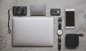 Eleganckie luksusowe prezenty: aparat, laptop, smartfon, zegarek i głośnik. Idealny zestaw dla nowoczesnego podróżnika.