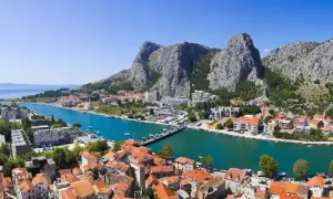 Widok na miasto Omiš w Chorwacji, z rzeką Cetiną i górami w tle. To miejsce, gdzie warto zobaczyć, jak historia łączy się z pięknem natury.