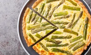 Eine köstliche Spargel Quiche mit einem goldbraunen Teigrand und saftiger Füllung, belegt mit frischem Spargel.