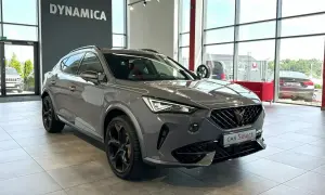 Szary Cupra samochod z czarnymi felgami stoi w salonie.