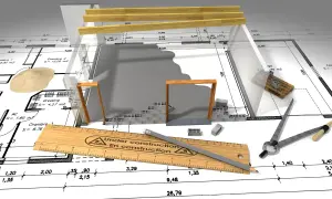 Budowa domu bez kredytu a urząd skarbowy: plan, materiały budowlane i narzędzia na tle projektu.