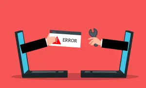 Dwie ręce wychodzące z laptopów. Jedna trzyma komunikat "ERROR", druga klucz francuski. Strona w przebudowie.