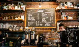 Pizarra con lista de precios de bebidas para bares, incluyendo cafés, tés y extras. ¡Una guía útil para la lista de precios de bebidas para bares 2026!