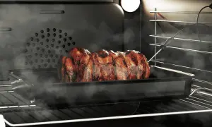 Soczysta pieczeń w piekarniku, wykorzystująca funkcję grill, paruje i apetycznie się rumieni.