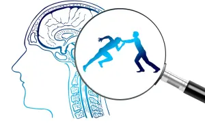 Ilustracja profilu głowy z widocznym mózgiem, powiększa dwie sylwetki w walce, symbolizujące opór w psychoterapii.
