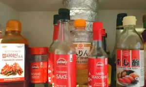 Szafka z azjatyckimi przyprawami: sosy, mirin seasoning, sake, sezam.