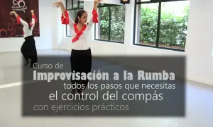 Mujer bailando flamenco con falda negra y blusa de lunares rojos. Aprende el ritmo de rumba flamenca y el control del compás.