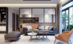 Soggiorno moderno con divano grigio, poltrona color terra e tavolini. Idee originali per arredare casa con stile e comfort.