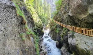 Wilder Wasserfall bei Zell am See, mit Holzsteg entlang der Felswand.