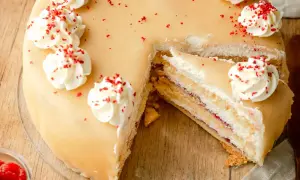 Ein köstliches Marzipantorte Rezept: saftiger Kuchen mit Marzipan, Sahne und Himbeermarmelade, verziert mit Tupfen und roten Streuseln.
