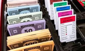 Monopolowe banknoty o nominałach 10, 20, 50, 100 i 500 oraz karty własności nieruchomości.