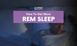 A man sleeps peacefully in bed, with text overlaying the image: "How To Get More REM SLEEP".