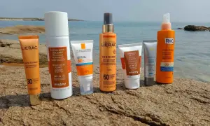 Des crèmes solaires Lierac, Sisley, La Roche-Posay, Skinceuticals et Roc sur des rochers. Elles servent à protéger la peau des rayons UV et à prévenir le vieillissement cutané.