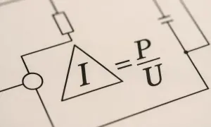 Wzór na natężenie prądu: I = P/U. Schemat obwodu elektrycznego z symbolem amperomierza i elementami.