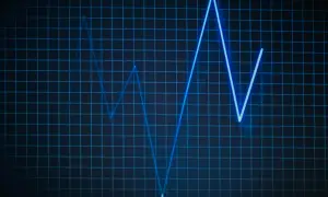 Niebieska linia na siatce, przypominająca wykres EKG lub wskaźnik biosotal, pokazuje zmienne wartości.