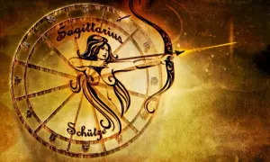 Znak zodiaku Strzelec, symbolizowany przez łucznika z łukiem i strzałą, w złotej oprawie zodiakalnego koła.