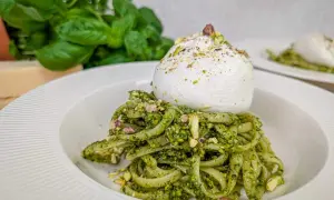 Makaron z pesto pistacjowym i burratą, posypany posiekanymi pistacjami. Pyszne danie, które zachwyca smakiem i wyglądem.