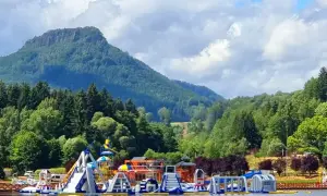 Kolorowy park wodny na **zalewie radkowskim** z górami w tle.