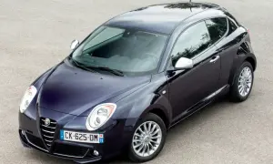 Elegancki, granatowy Alfa Romeo MiTo na tle asfaltu. Wiele osób szuka alfa romeo mito opinie, by poznać ten model.