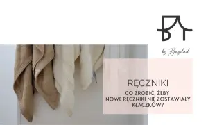 Nowe ręczniki wiszą na wieszaku. Dowiedz się, jak sprawić, by ręczniki nie zostawiały kłaczków na ciele.