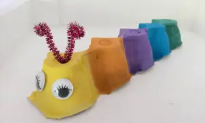 Bunte **Raupe basteln** aus Eierkartons mit Glubschaugen und Fühlern.