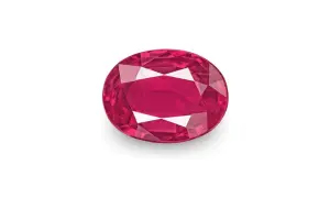 Un rubí, una **piedra preciosa roja** de intenso color, brilla con facetas que capturan la luz.