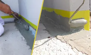 Arbeiter versiegeln Fugen der Terrasse mit einer grauen Masse. Gelbes Klebeband schützt die Wand.