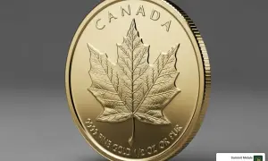 Złota moneta z wytłoczonym kanadyjskim liściem klonowym i napisem "CANADA".