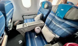 Komfortowe fotele w klasie premium economy LOT. Poduszka i koc czekają na pasażera.