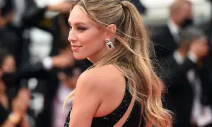 Elegancki kucyk kucyk na wesele. Blond włosy spięte w wysoki kucyk, błyszczące kolczyki, czarna, cekinowa sukienka.