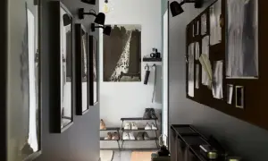 En avlång hall med inspiration från stadsliv. Tavlor, skohyllor och en anslagstavla skapar en funktionell och stilfull entré.
