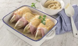 Endives au jambon gratinées, un plat classique dont l'origine est souvent attribuée à Bruxelles. Servi avec une purée onctueuse.