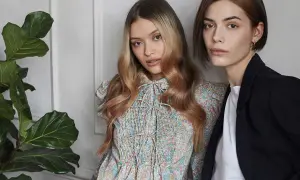 Due modelle con capelli biondi e castani, una con abito floreale, l'altra con blazer. L'armocromia inverno capelli valorizza i loro toni.