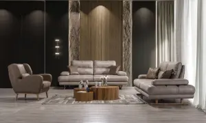 Modern vardagsrum med grå lädersoffa och fåtölj. Perfekt soffa inspiration för ett stilrent hem.