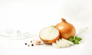 Cebula w ciąży, gotowa do przygotowania zdrowego posiłku. Obok cała cebula, połówka, plasterki, czosnek, pieprz i natka pietruszki.