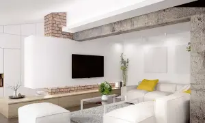 Nowoczesny salon z białymi sofami i pufami. Ceglany podciąg zamiast ściany nośnej dodaje industrialnego charakteru.