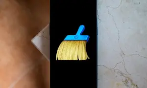 Un teléfono muestra el icono de una escoba azul y amarilla, símbolo del mejor limpiador de móvil gratis.