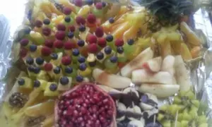 Eine bunte, einfach zubereitete obstplatte mit Ananas, Sternfrucht, Beeren, Granatapfel und Kiwi.