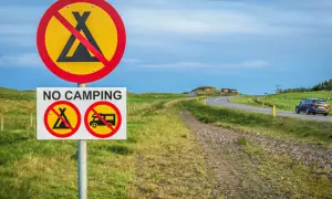 Schilder verbieten das Zelten und Wohnmobilfahren. Kein **island wildcampen** hier, nur eine Straße mit einem Auto.