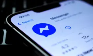 Ikona aplikacji Messenger na ekranie telefonu. Widoczne dymki czatu, wyszukiwarka i informacja o wieku 12+.