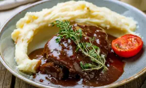 Schab w sosie własnym, podany z purée ziemniaczanym i pieczonym pomidorkiem. Aromatyczny, domowy obiad.