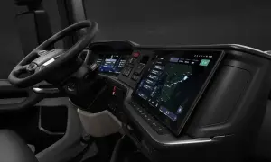 Vue du scania interieur cabine, avec volant, écrans tactiles affichant navigation et informations, et tableau de bord moderne.